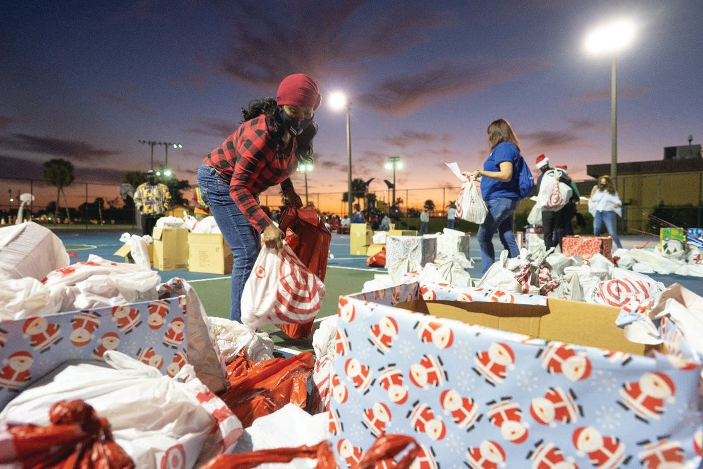 Volunteers help with sorting gifts to be delivered to families and local teenagers.